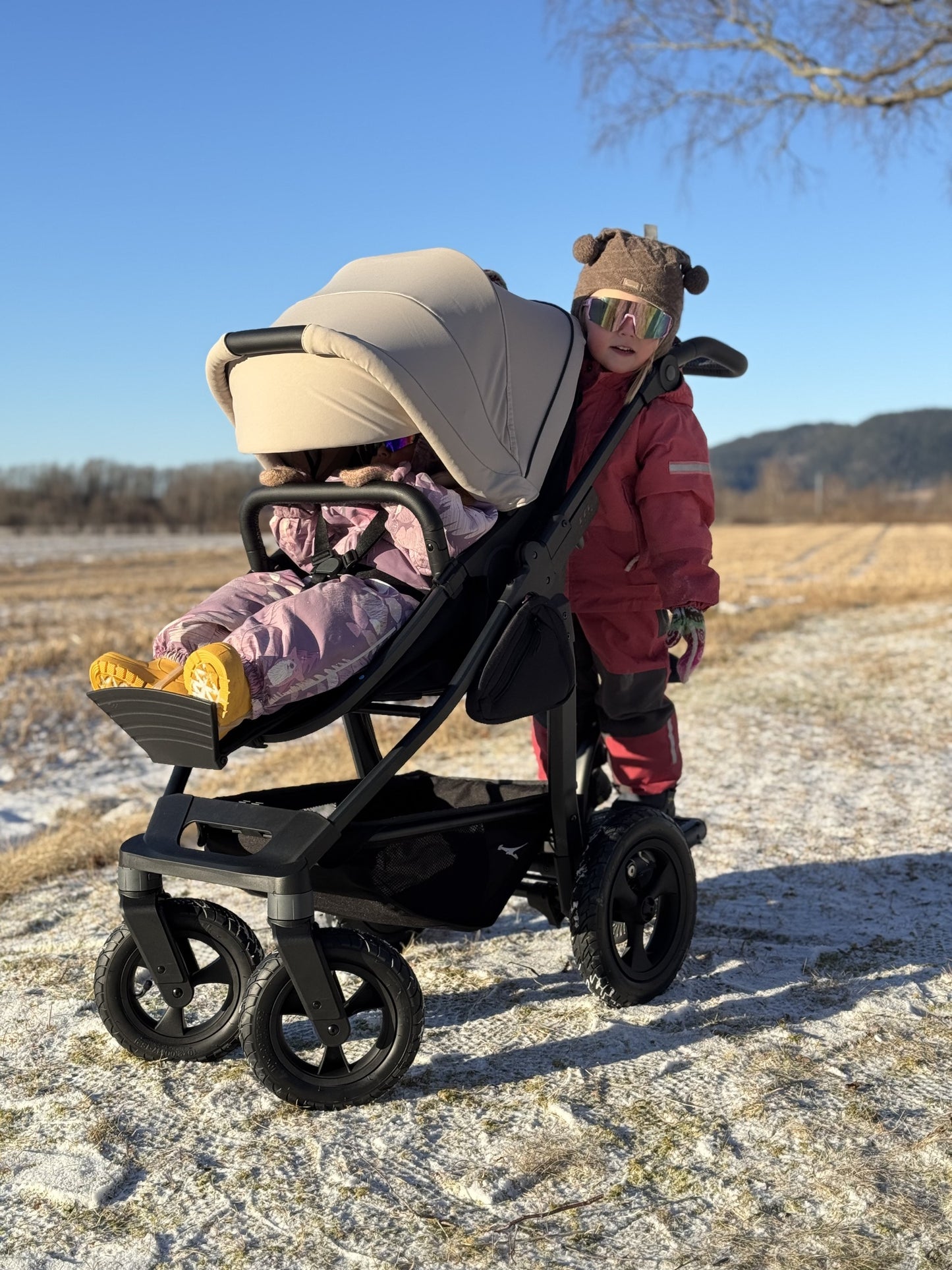Søsken på TFK Mono 4, med søskenbrett MultiBoard. To og fire år, kombidelen som er babybag først, så sittedel. Kan brukes begge veier.